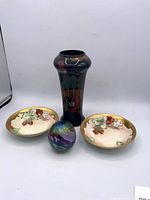 Group shot showing pottery vase, two porcelain bowls and glass paperweight