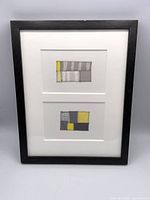 Full view of framed artwork showing both patchwork panels and frame