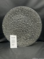 Full view of round bubble-textured glass platter front