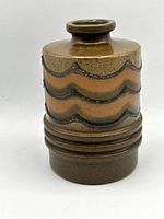 Front view of brown ceramic vase with raised wavy bands