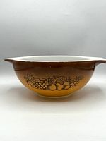 Side view showing brown-to-orange ombré exterior and fruit motif.