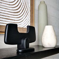 Front angled view of black mango wood bull sculpture displayed on console