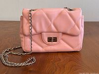 Front view of pink quilted Fabrika bag with chain strap