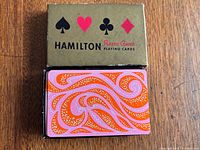 Deck showing card back design alongside gold-tone box lid