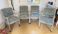 Four matching upholstered armchairs grouped together