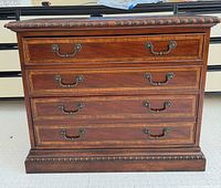 Front view showing full dresser, hardware, carved trim