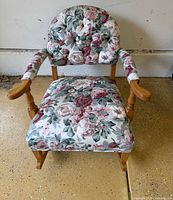 Front view showing floral upholstery, wooden arms and seat