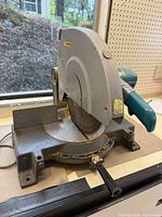 Front angled view of Makita LS1440 miter saw showing overall condition and taped handle
