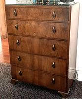 Front view showing full dresser, five drawers, brass pulls, feet