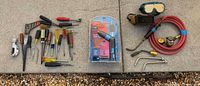 Overall lot showing torch assembly, cordless screwdriver package, welding goggles, hose with regulator and array of hand tools
