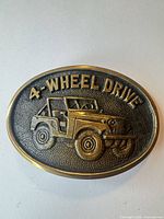 Front view of belt buckle showing Jeep motif and text