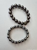 Both bracelets laid flat showing overall design and bead styles