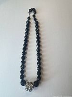 Full view of the faceted black bead necklace with rhinestone focal