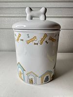 front view of ceramic dog treat jar with lid showing graphics