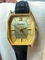 Front view of Cosmo quartz watch showing dial, case, strap condition