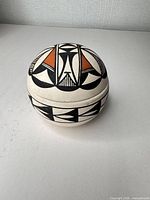 Lidded bowl front view showing geometric paint