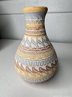 Front view of multicolor hand-carved terracotta vase