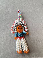 Full view of the handmade multicolour beaded keychain with loop and fringe