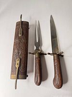 Dagger, fork and scabbard laid out showing overall design and materials