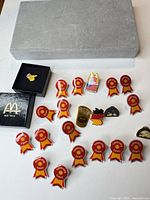 All pins and two presentation boxes laid out on surface