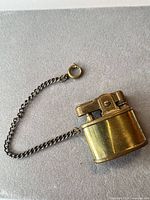 Entire lighter with attached chain visible