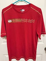 Front view of red 49ers jersey on hanger