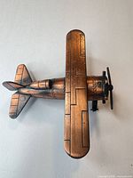 Top view of bronze tone metal biplane showing overall shape and finish