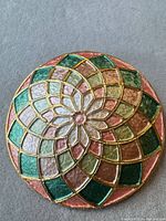 Front view showing mandala enamel design and colour palette