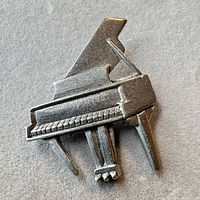 Front view of pewter piano brooch
