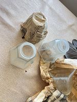 Three etched floral frosted glass shades, one wrapped