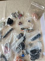 Overview of bagged jewelry pieces on fabric surface