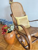 Full view of rocking chair showing bentwood frame, cane seat and back