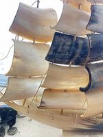 Close view of horn sails showing color variation and brass connectors