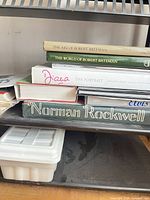 Stack of six hardcover art and photography books showing spines and titles