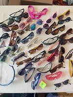 Full tabletop view showing all sunglasses spread out