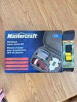 Front of Mastercraft Hawkeye Laser Level Kit box alongside Sure Strap tie-down package