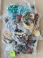 Top view of assorted jewelry in bags highlighting turquoise beads and shell pieces
