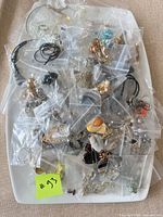 Tray with bagged costume jewelry pieces