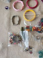 Overview of bangles, stretch bracelet, bagged bead items and charms