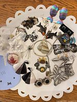 Overview of entire lot on white tray showing earrings, pendants, chain and necklaces