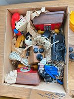 Boxed assortment of novelty telephones, handsets, cords and chargers