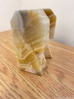 Pair of banded onyx bookends standing on table
