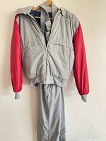 Gray/red hooded ski jacket with matching gray ski pants