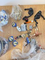 All mixed Star Wars figure parts spread on wooden surface, showing R2-D2, C-3PO, black torsos, Stormtrooper piece, Darth Maul, Jar Jar Binks and loose heads.