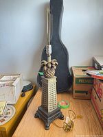 Full view of pineapple motif table lamp with harp, cord and plug visible