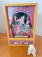 Front view showing circus clown graphic and closed drawer