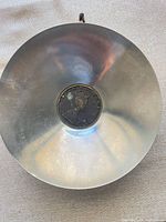 Front of pewter bowl showing coin medallion and surface condition
