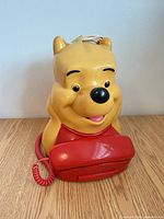 Front view of Winnie the Pooh phone showing handset and cord