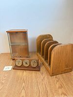 Display cabinet, letter sorter, and weather station grouped on tabletop