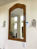 Mirror and two of the wall sconces mounted on wall